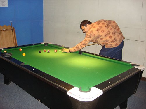 Man playing pool in indoor setting.
